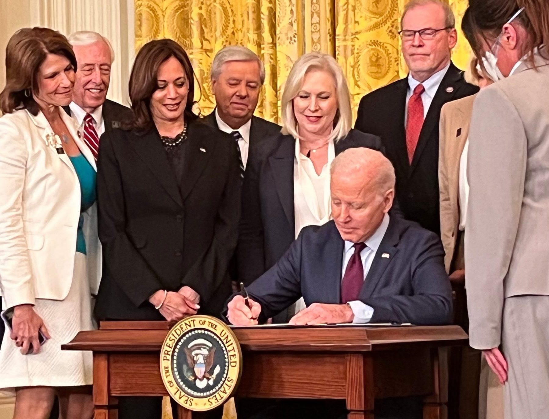 Photo of President Biden signing prohibition of arbitration of sexual harassment claims