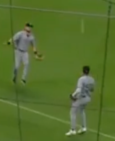 Freeze-frame of two baseball players watching a pop fly drop between them with neither one catching it