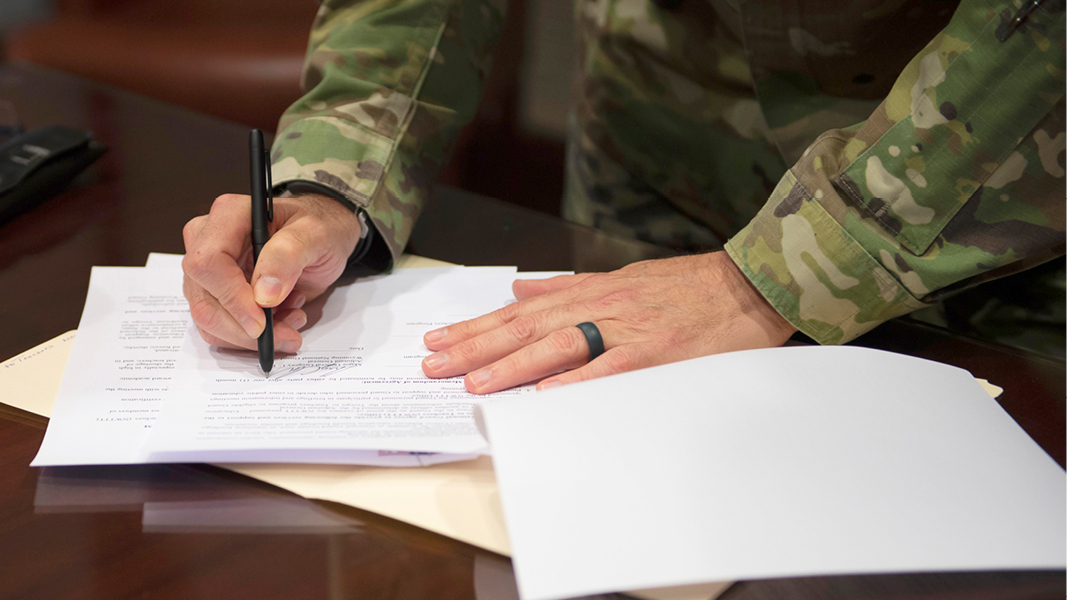 Soldier signing documents - from DOD Office of Financial Readiness